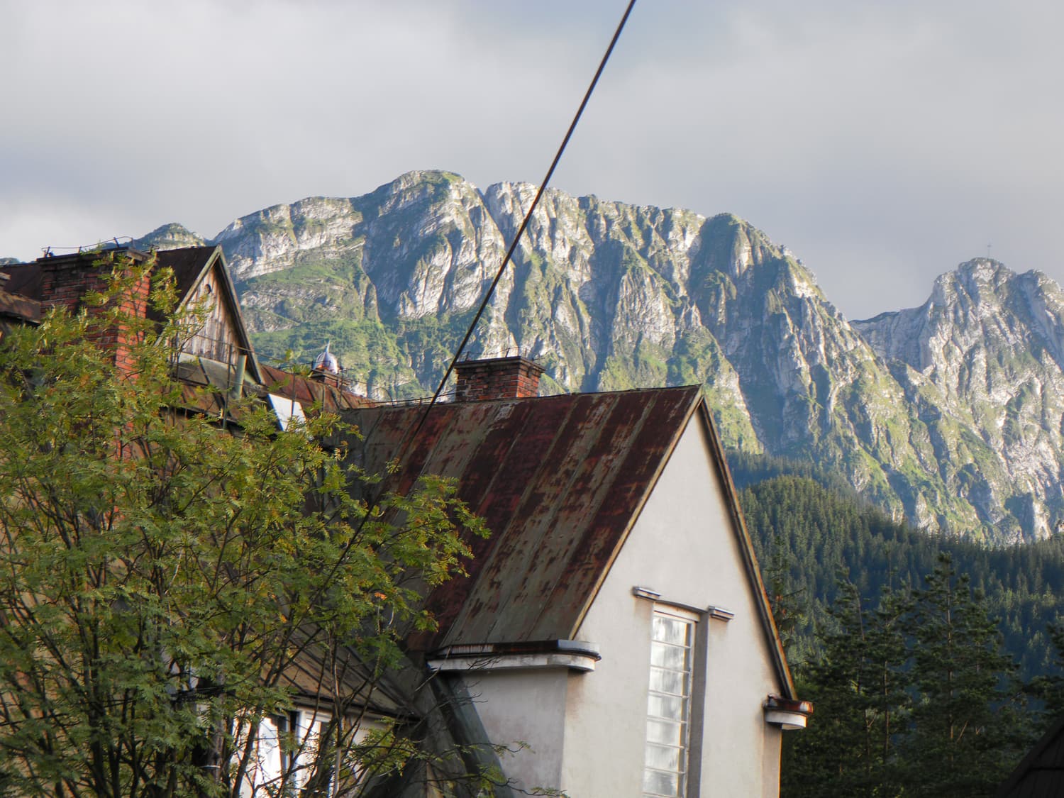 The limestone massif of Giewont rising above a wooden house in Zakopane