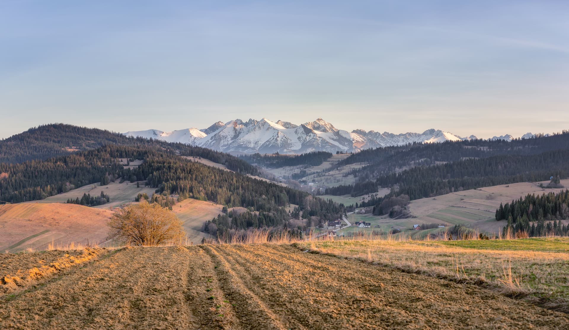 The Tatra Mountains seen across autumn fields from the Polish Spiš region