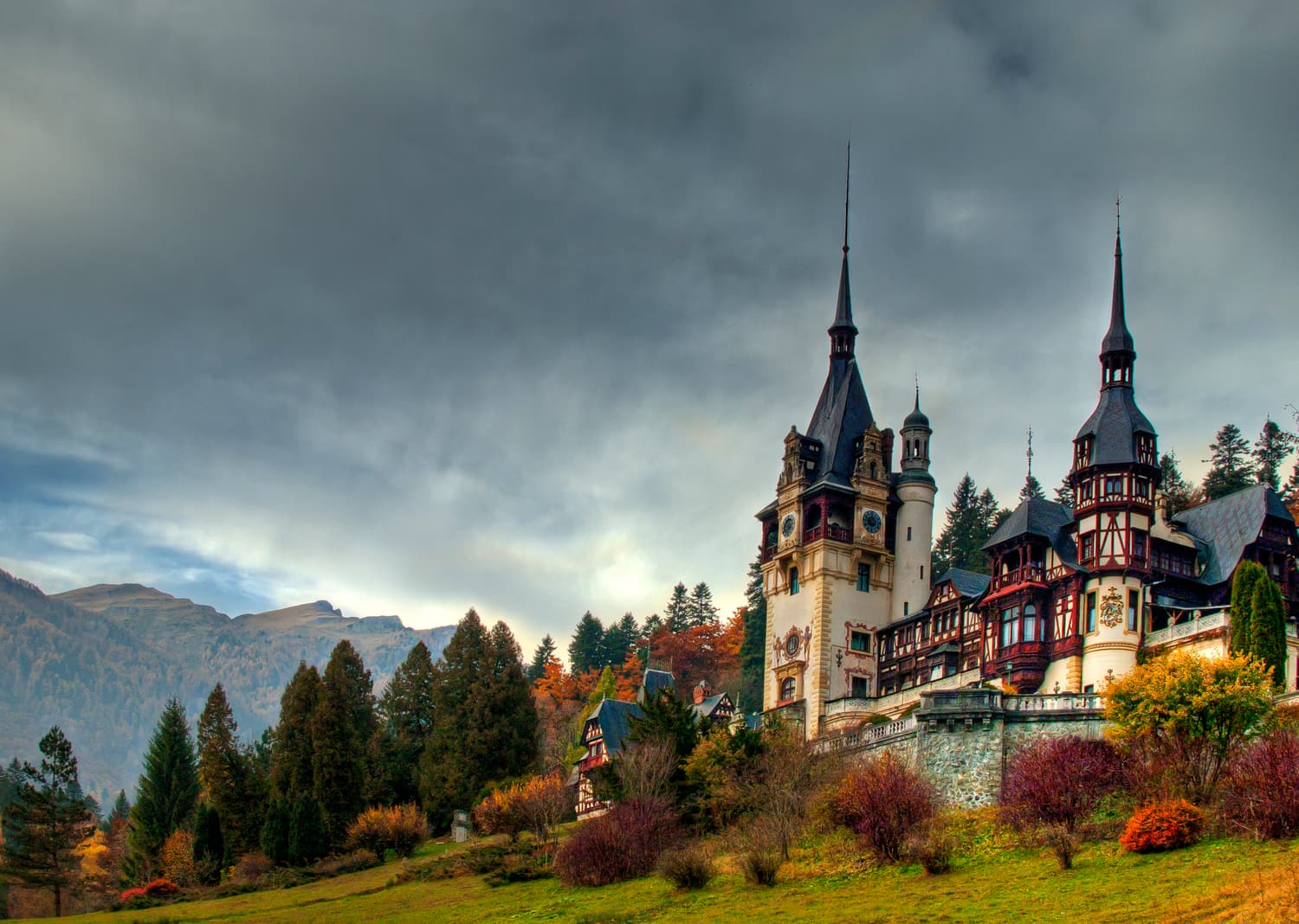 Peleș Castle in Sinaia surrounded by autumn trees